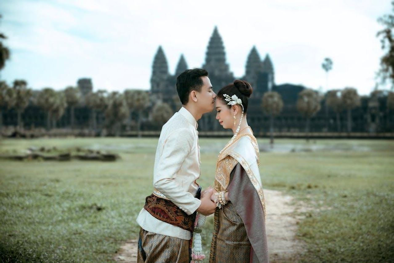 Source: HANUMAN PHOTO STUDIO🏕️📸 - pexels - A couple in traditional Cambodian attire embracing at Angkor Wat, a symbol of timeless love.