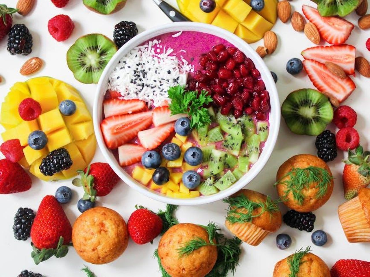 Source: Jane Trang Doan - pexels - Vibrant smoothie bowl topped with assorted fresh fruits and muffins, perfect for a healthy snack.