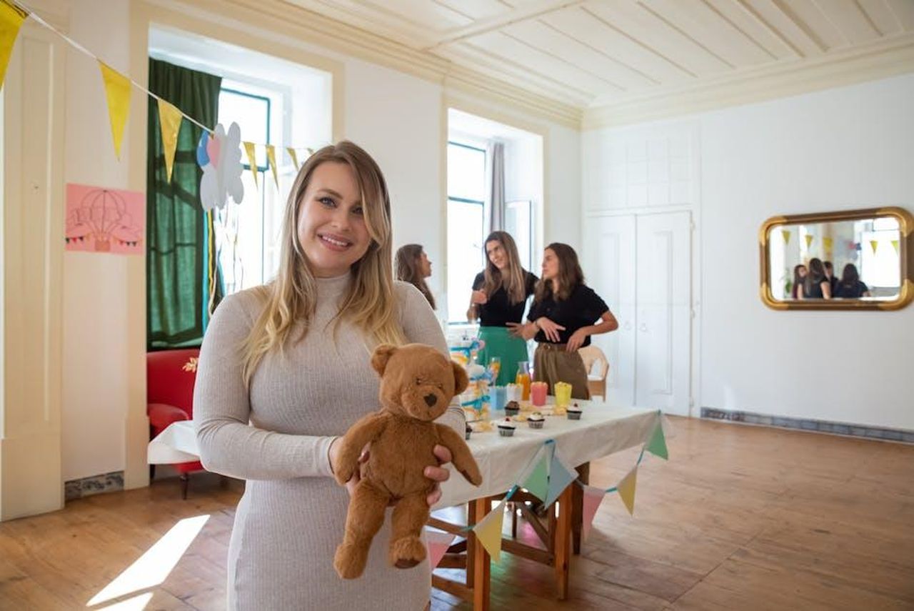 Source: Kampus Production - pexels - A cheerful gathering with friends celebrating a baby shower indoors with decorations and refreshments.