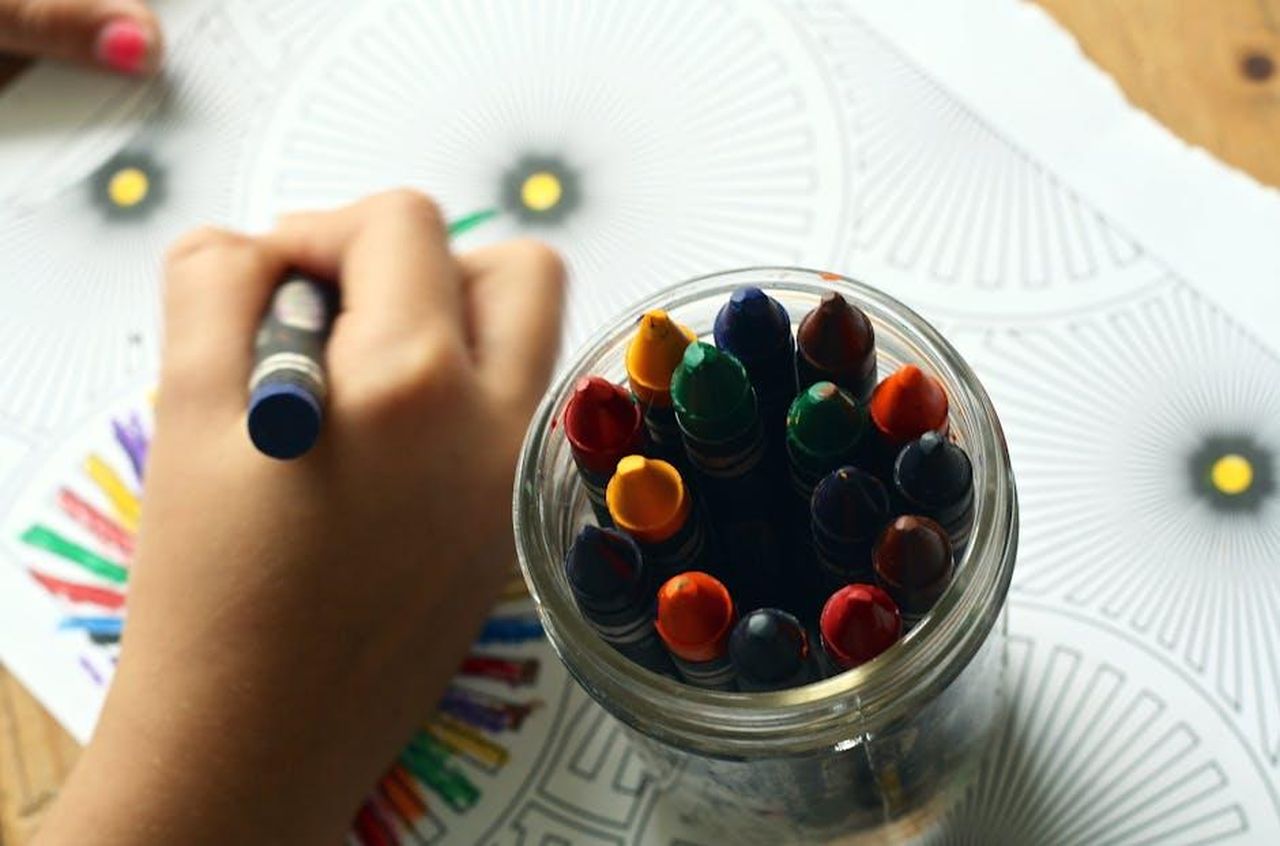 Source: Pixabay - pexels - A child drawing with colorful crayons, fostering creativity and fun in a learning environment.