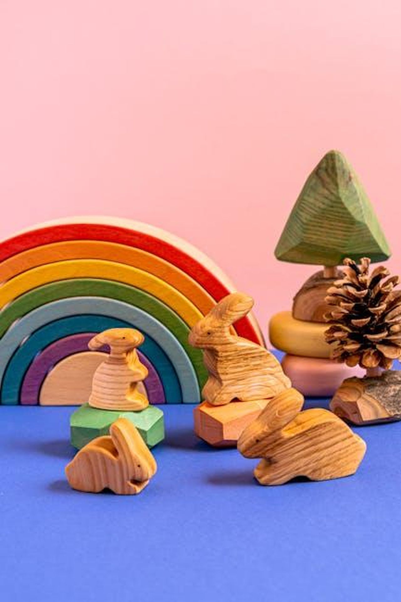 Source: Antoni Shkraba - pexels - Charming wooden animal figurines with a colorful rainbow in a playful still life setup.