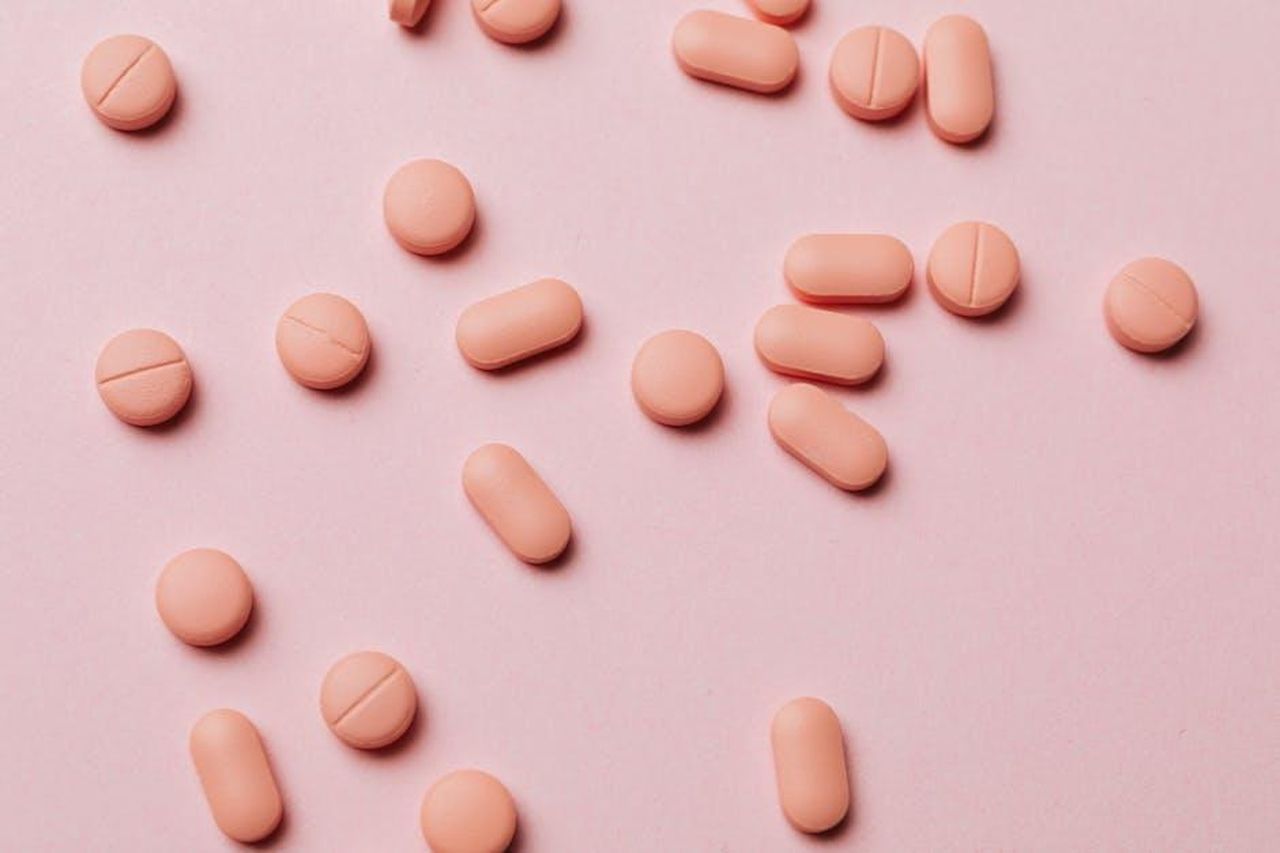 Source: Photo By: Kaboompics.com - pexels - Flat lay photo of pink pills on a pastel pink background, ideal for pharmaceutical themes.