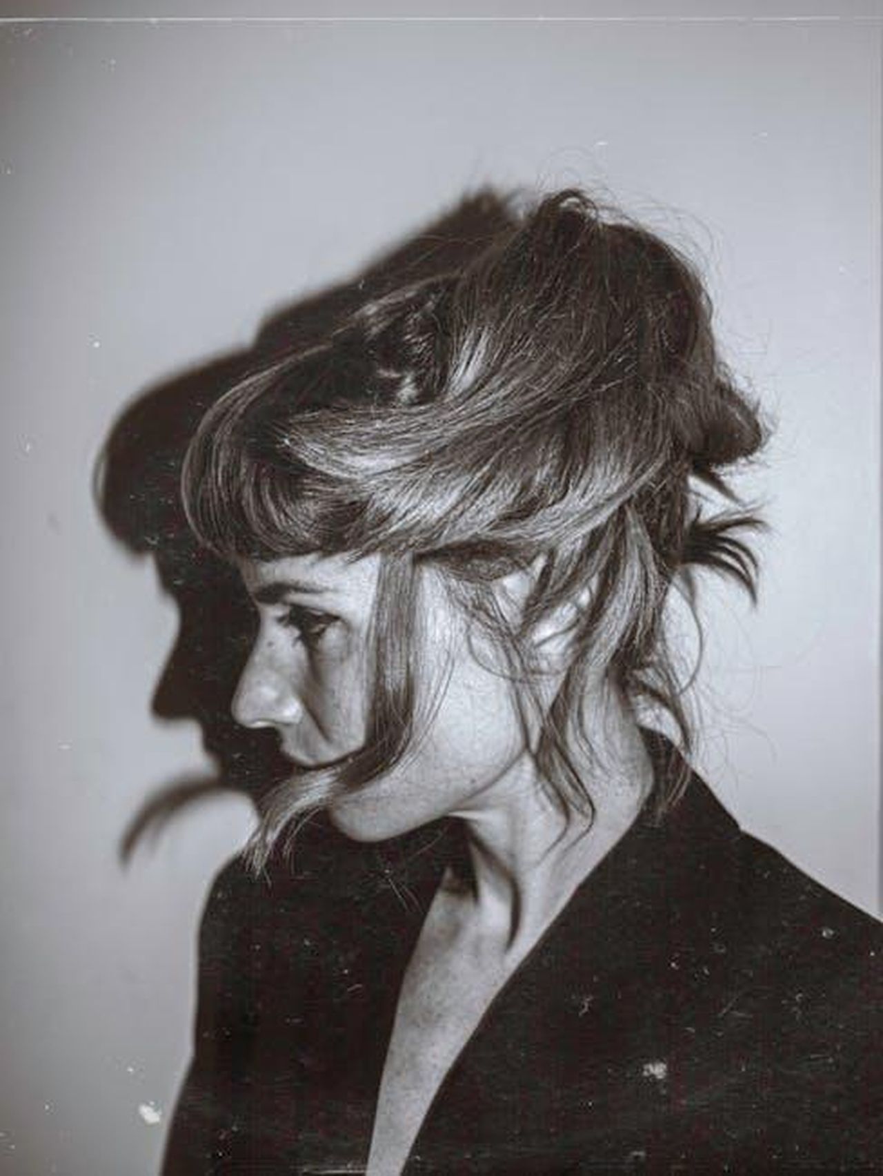 Source: Lany-Jade Mondou - pexels - Grayscale portrait of a woman with messy hair and shadow profile.
