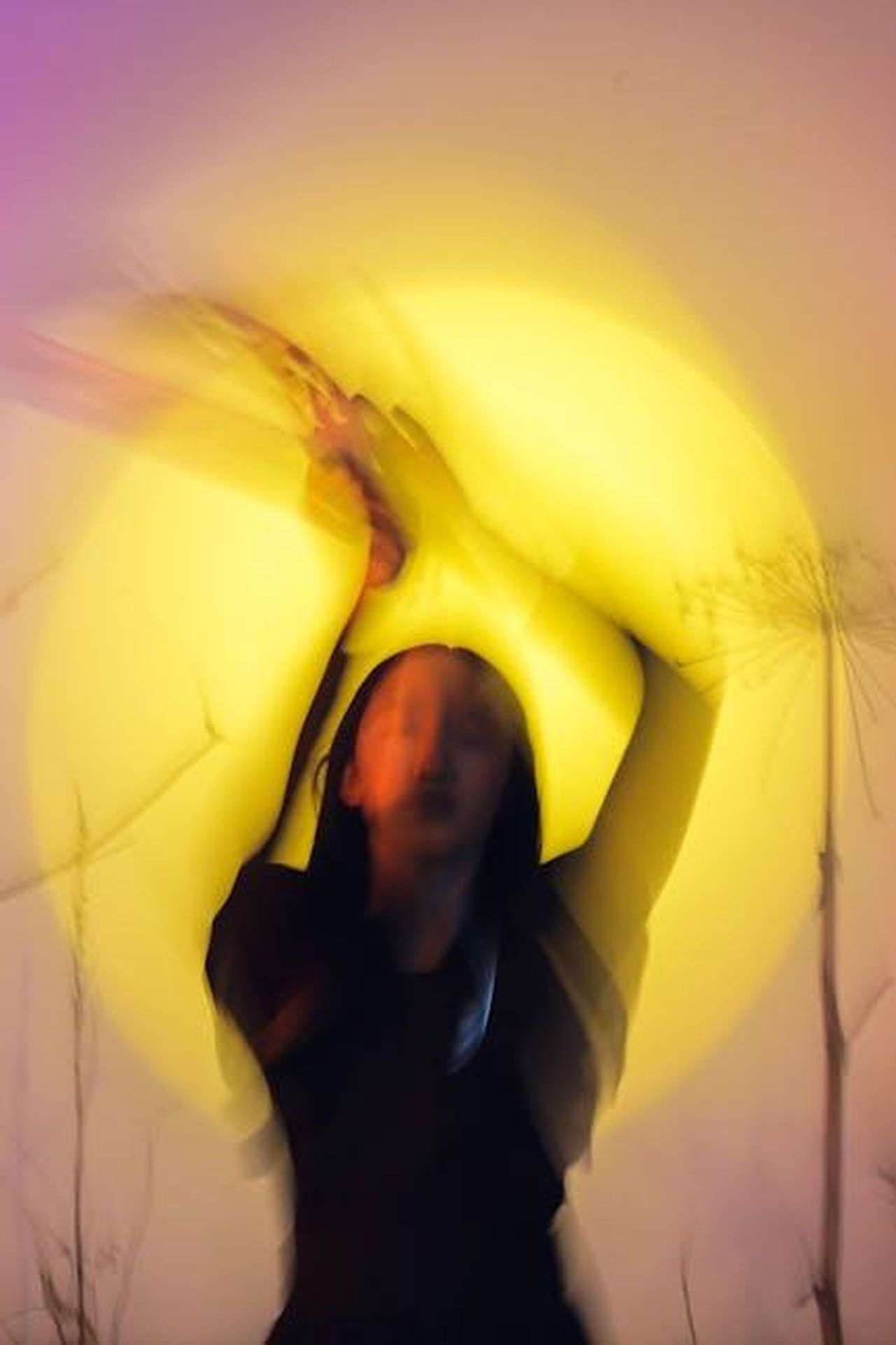 Source: cottonbro studio - pexels - Abstract artistic portrait of a woman with blurred motion and vibrant light effects, creating a conceptual feel.