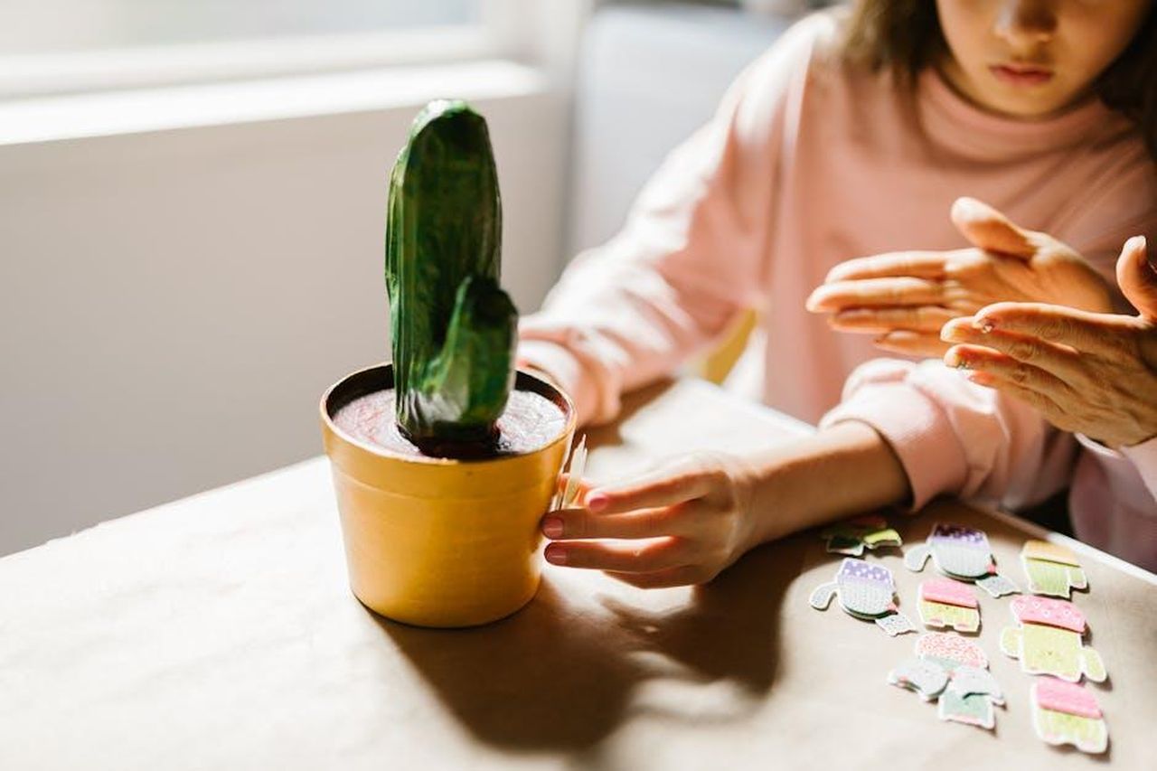 Source: RDNE Stock project - pexels - Children engaging in arts and crafts with a paper cactus by the window.