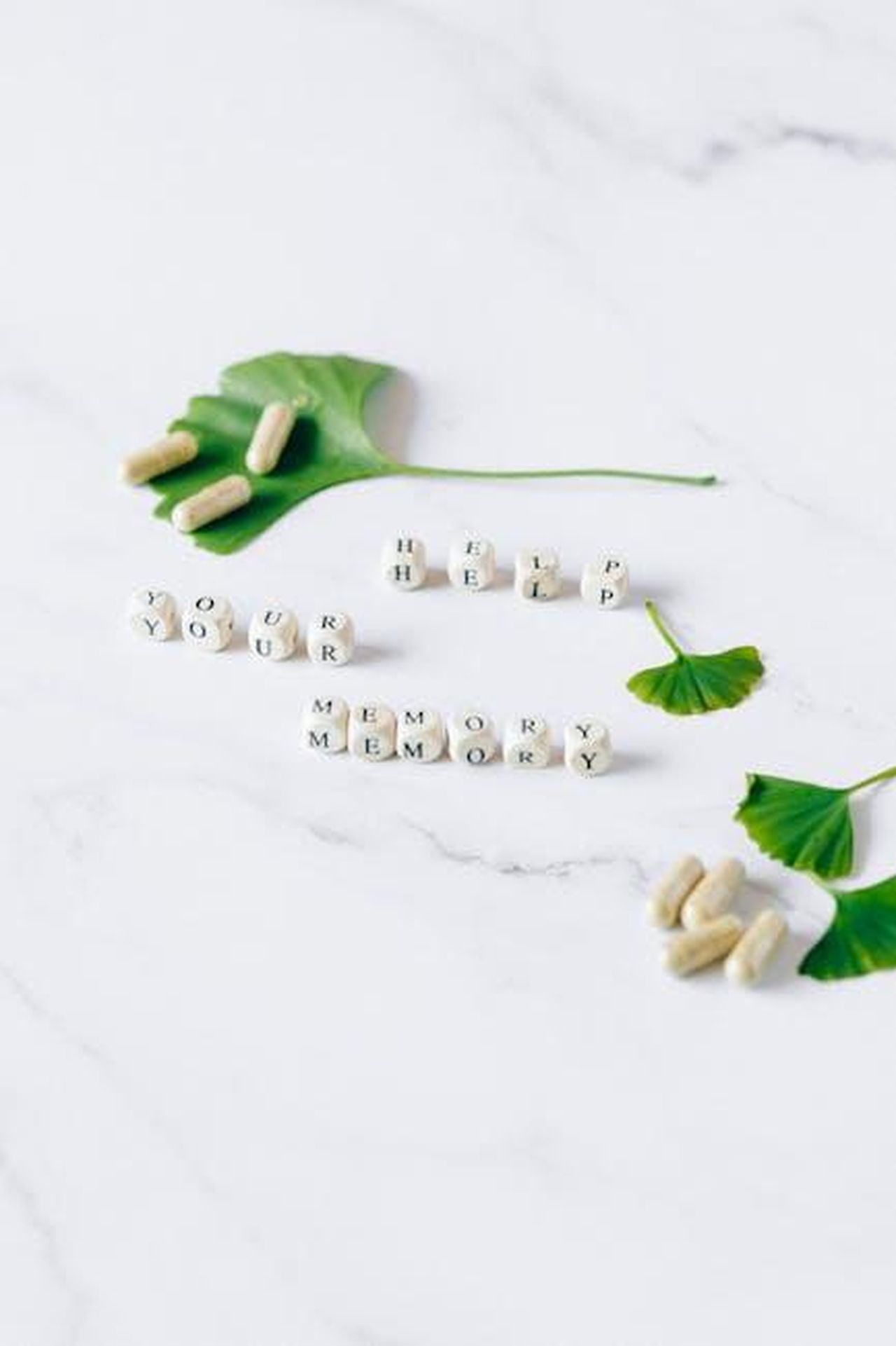Source: Nataliya Vaitkevich - pexels - Top view of Ginkgo biloba leaves and capsules for memory enhancement.