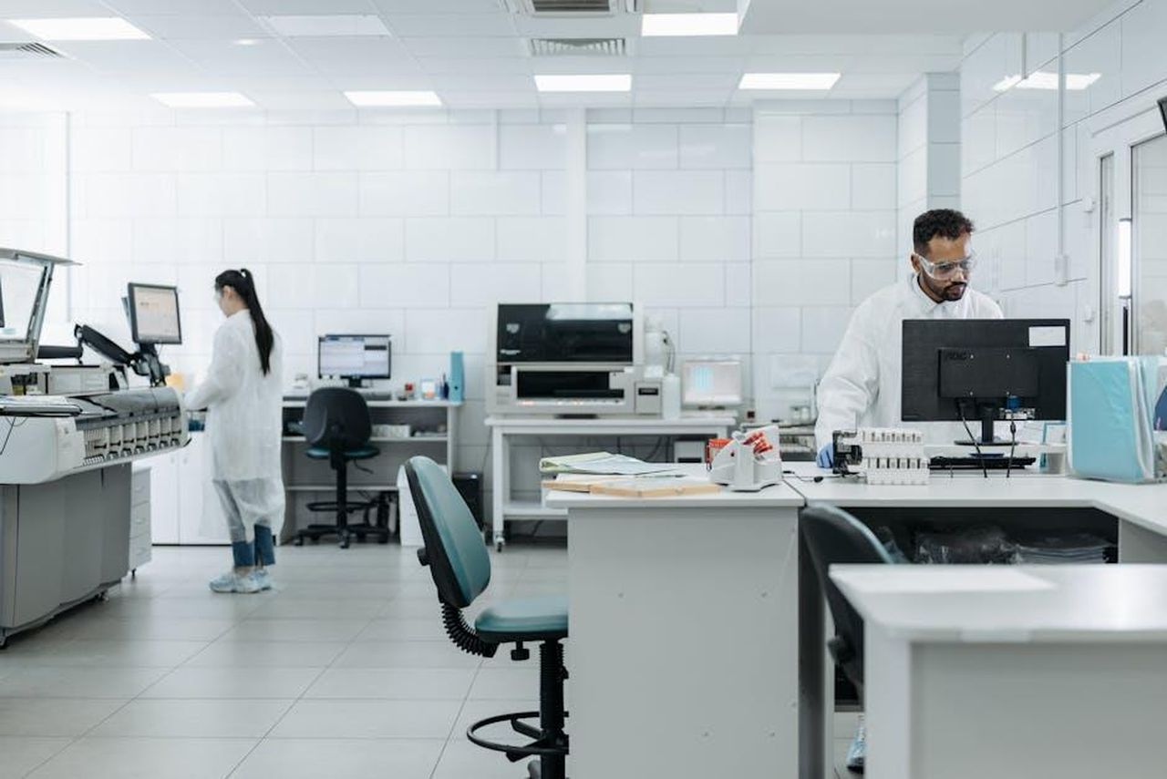 Source: Pavel Danilyuk - pexels - Researchers in protective gear conduct experiments in a high-tech lab environment.