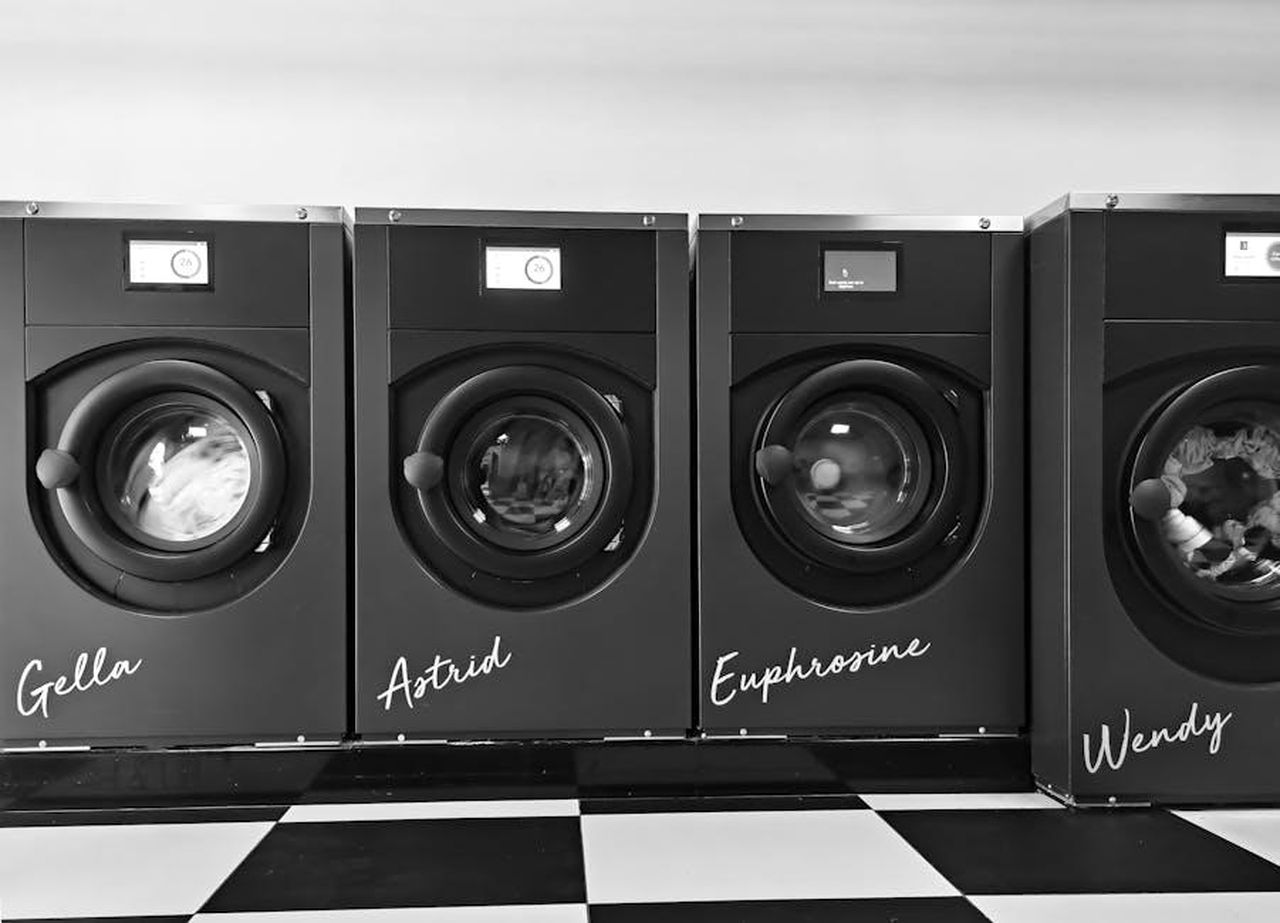 Source: Jan Van Bizar - pexels - Grayscale image of four modern washing machines in a self-service laundry.