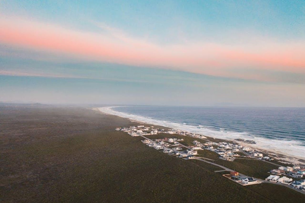 Source: Taryn Elliott - pexels - A breathtaking aerial view of a seaside community under a vibrant pastel sky.