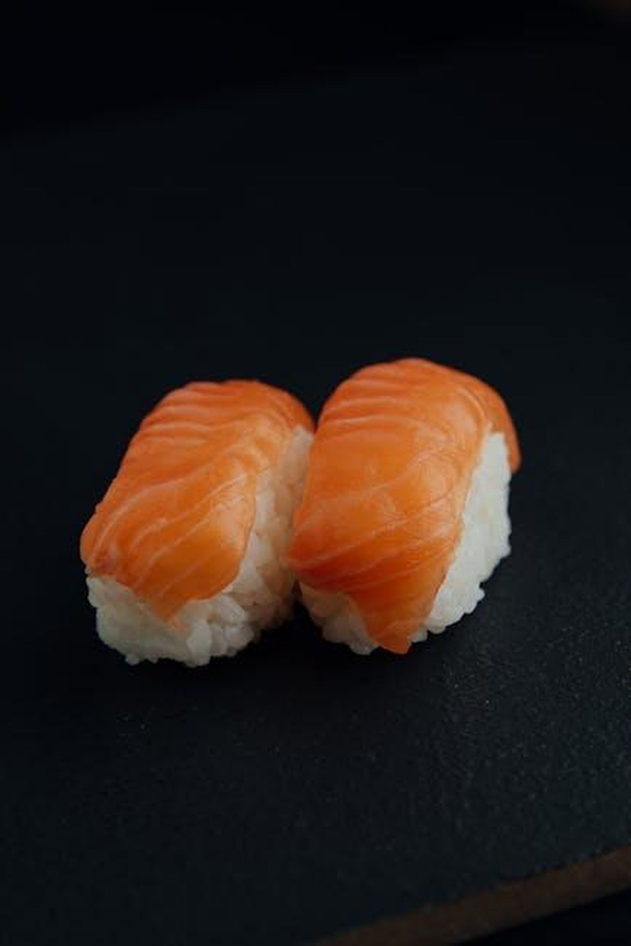 Source: Olga Lioncat - pexels - From above of delicious fresh sushi with white rice and tasty salmon on black background