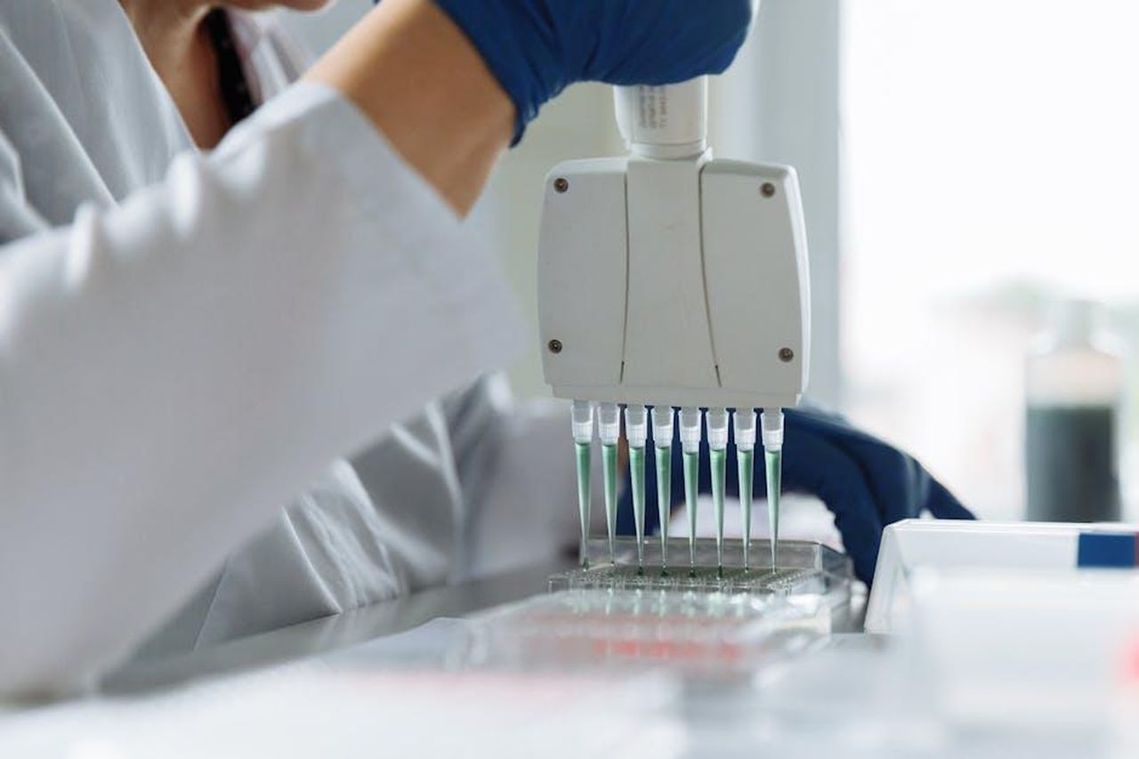 Source: Thirdman - pexels - A scientist wearing a lab coat uses a multichannel pipette for liquid handling in a lab setting.