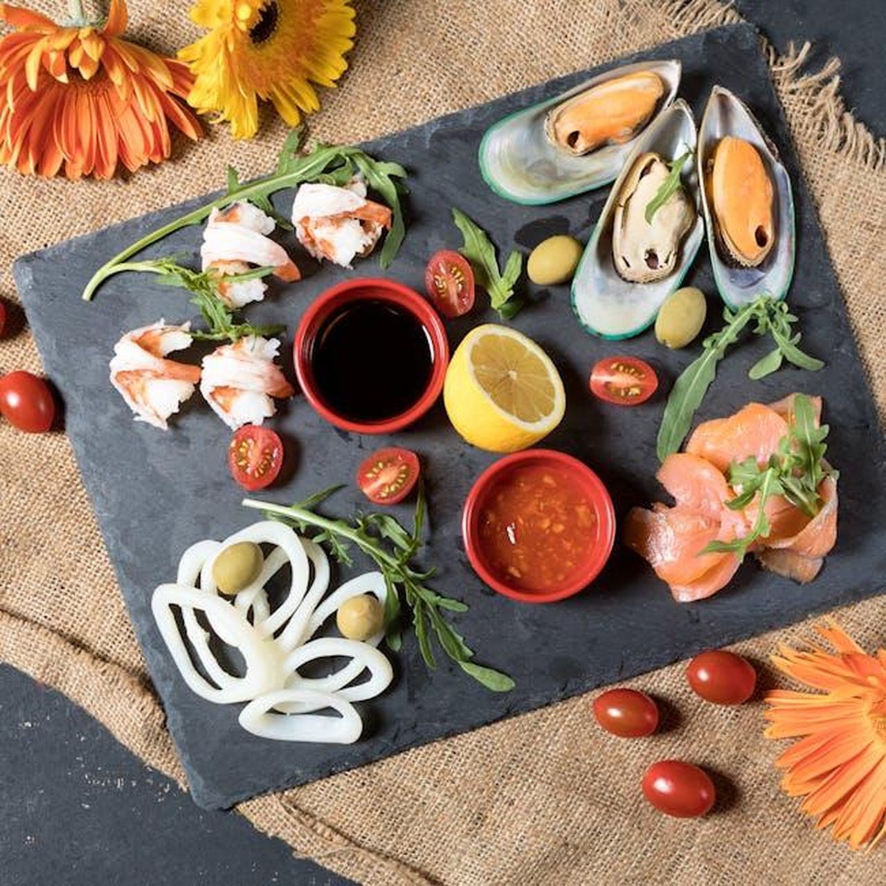 Source: Farhad Ibrahimzade - pexels - A vibrant seafood platter featuring fresh mussels, shrimp, smoked salmon, and more on a stone plate.