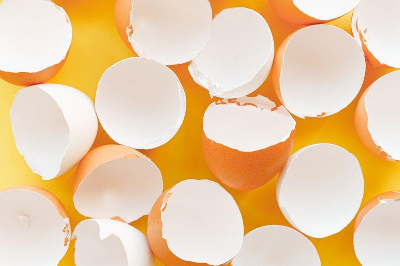 Source: Anna Shvets - pexels - A minimalist image of scattered eggshells on a bright yellow background.