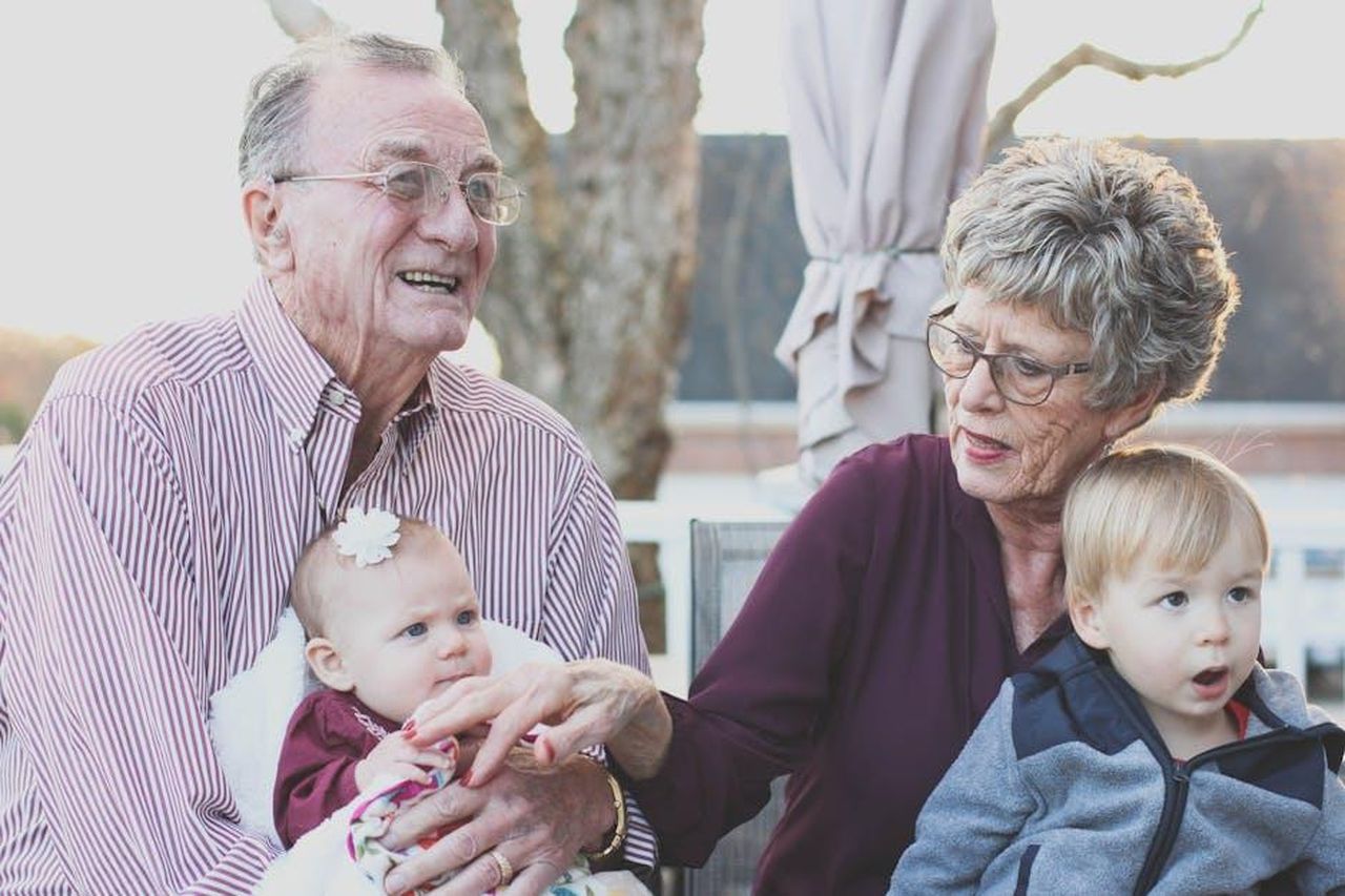 Source: Pixabay - pexels - Grandparents spending joyful moments with their grandchildren in an outdoor setting, captured candidly.